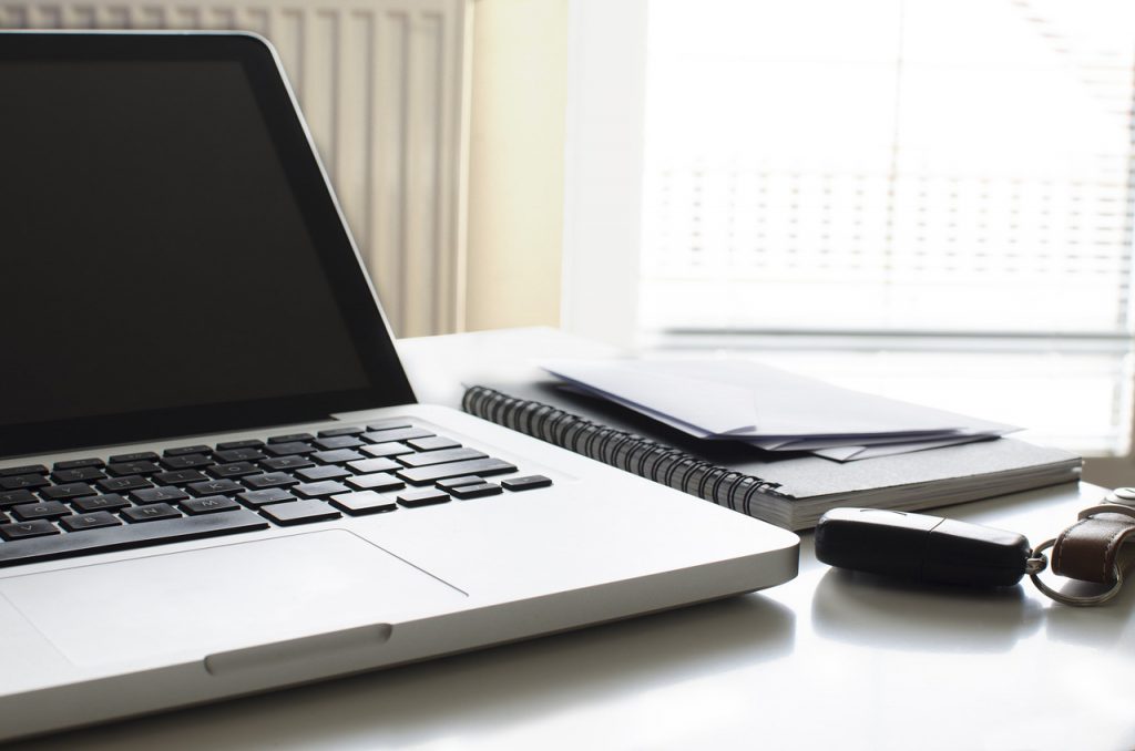 Laptop on desk with keys
